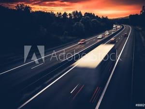 Trucks Driving on Highway at Sunset