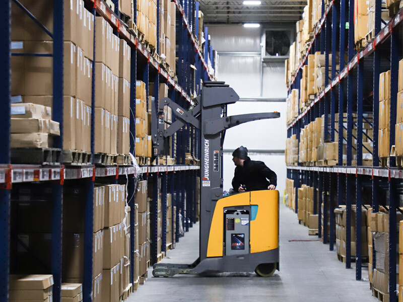 Forklift moving pallets in a warehouse