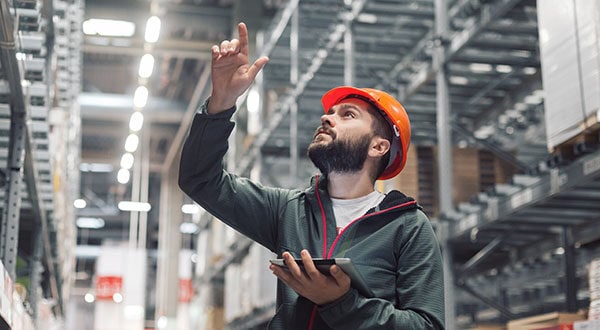 Man Looking up in a Warehouse
