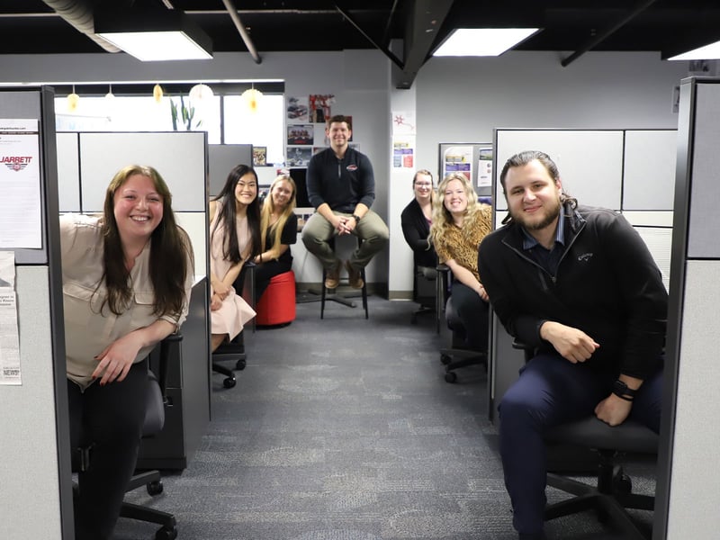Coworkers smiling from their desks